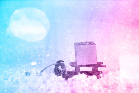 Xmas concept with wooden sled and santa sack with gift. Neon tonedの写真素材
