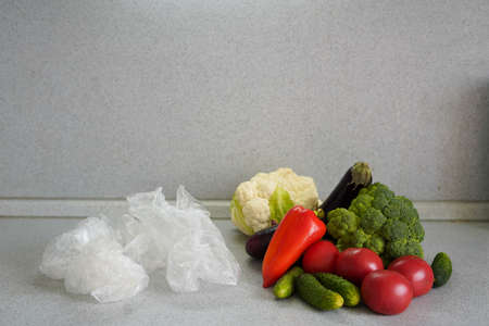 different vegetables lie in a row next to the plastic bags in which they were packed. zero waste...