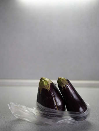 two eggplant in plastic bag
