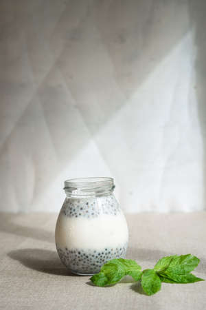 Healthy vanilla hemp pudding in a glass with fresh berriesの写真素材