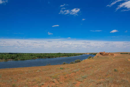The shore of nice river with cloudy skyの写真素材