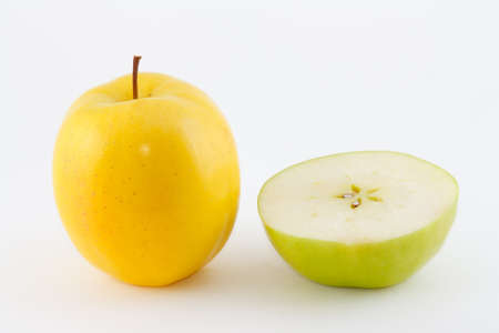 The yellow and green juicy fresh apples and slicesの写真素材