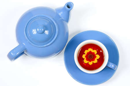 The blue kettle and cup of tea with nice flowers の写真素材