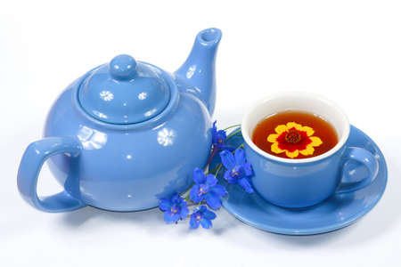 The blue kettle and cup of tea with nice flowers の写真素材