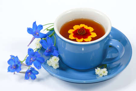 The blue cup of tea with nice flowers の写真素材