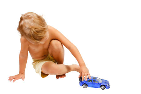 Little cute boy playing with blue toy carの写真素材
