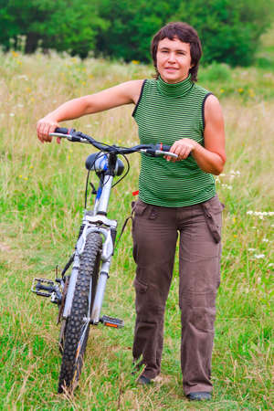 The woman walking on a bike outdoorsの写真素材