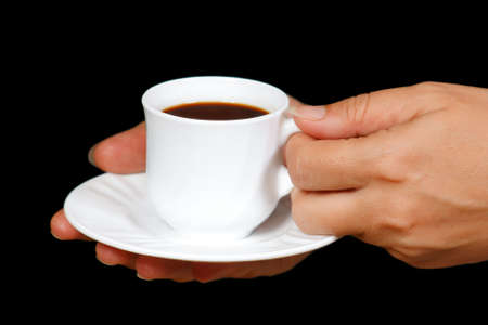 Hands with a cup of coffee on a black backgroundの写真素材