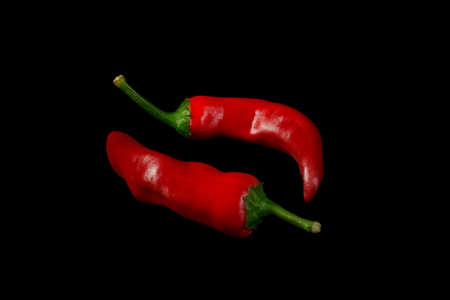 Red hot chili peppers on black backgroundの写真素材