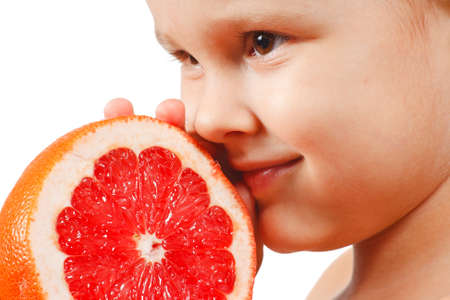 Little boy with a juicy pink grapefruitの写真素材