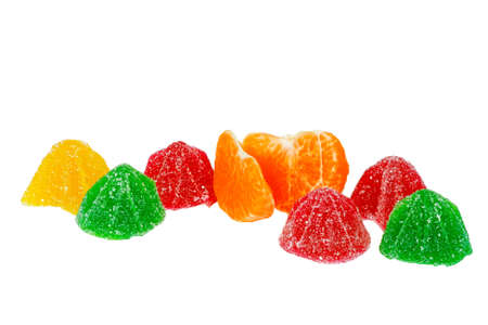 Coloured jelly sweets and tangerine on a white backgroundの写真素材