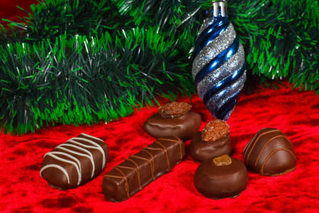 New Year's still life of chocolate candy on a red velvet