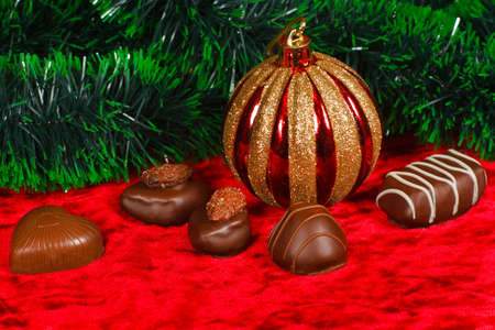 New Year's still life of chocolate candy on a red velvetの写真素材