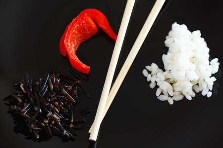 White and black rise and sweet pepper still lifeの写真素材