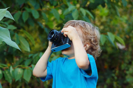 Young beautiful photographer with a camera outdoors