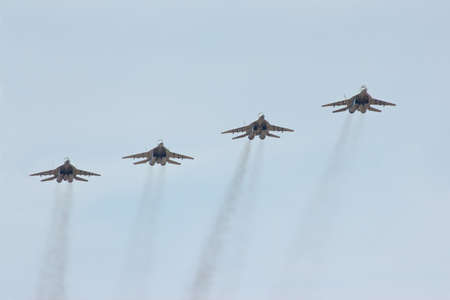 Four flying russian jet fighter MiG-29 in the cloudy skyのeditorial素材