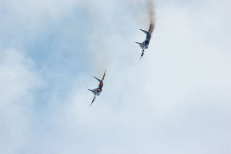 Two russian tactical jet fighter MiG-29 make virage in the cloudy skyのeditorial素材