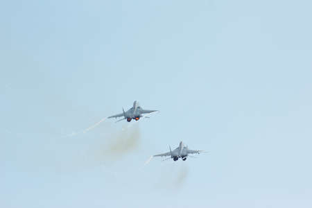 Two russian tactical jet fighter MiG-29 make maneuvers in the cloudy skyのeditorial素材