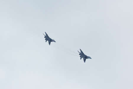 Two russian tactical jet fighter MiG-29 make attack in the cloudy skyのeditorial素材