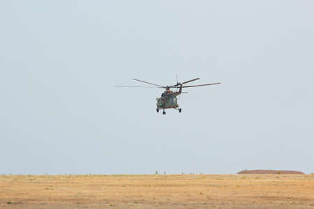 Russian flying military helicopter MI-8 in the cloudy sky