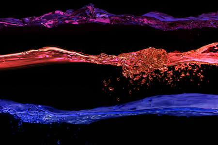 Set of water waves violet, pink and blue colors on a black backgroundの写真素材