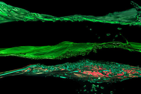 Water waves green colors on a black background