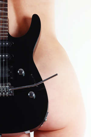 Perfect female body and a black guitar close upの写真素材