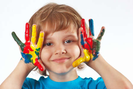 Little boy with painted hands on a white backgroundの写真素材
