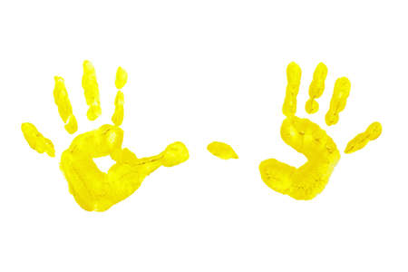 Yellow prints of children s hands isolated on a white backgroundの写真素材