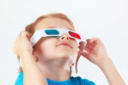 Little funny boy in 3D glasses on a white backgroundの写真素材
