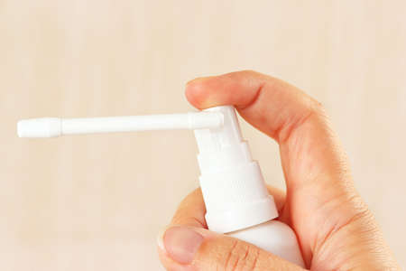 Female hand holding a medical aerosol close upの写真素材