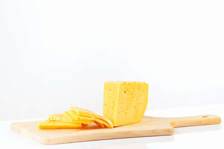 Sliced holland cheese on a cutting board closeupの写真素材