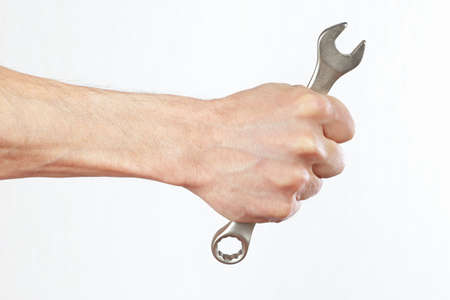 Hand of serviceman with a spanner closeupの写真素材