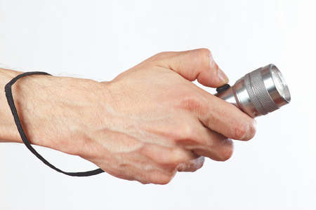 Hand holding a flashlight on a white backgroundの写真素材