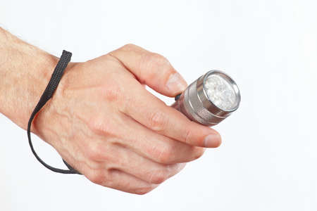 Hand holding a led flashlight on a white backgroundの写真素材