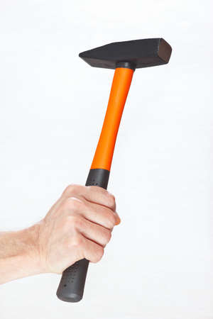 Hand of a workman holding a hammer on a white backgroundの写真素材