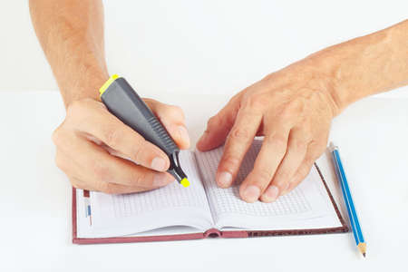Hand written notes in yellow marker a notebook on a white background