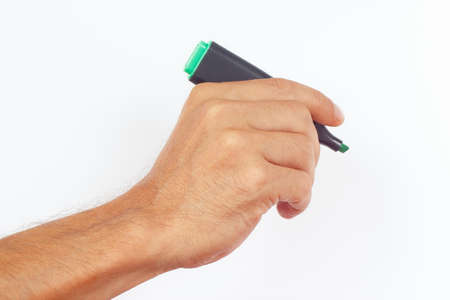 Hand holding a green marker on a white backgroundの写真素材