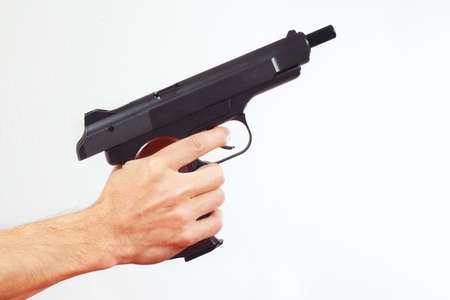Hand with discharged pistol on a white backgroundの写真素材