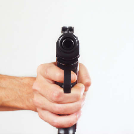 Hand with gun pointing forward close upの写真素材