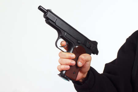 Hand with discharged semi-automatic pistol on a white backgroundの写真素材
