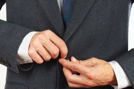 Man fastened the buttons on his business suit close upの写真素材