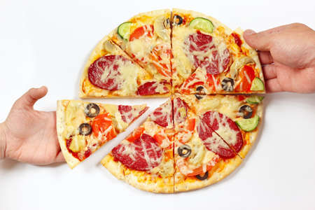 Hands of a man and a child are taking pieces of a pizza