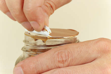 Hands opening a jar of instant coffee