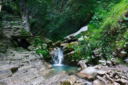 A small waterfall in a mountain forestの写真素材