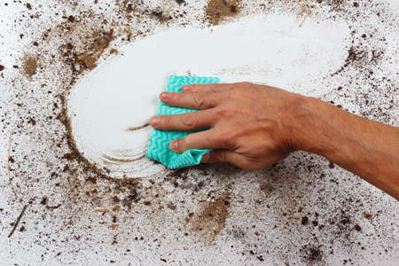 Hand with cloth wiping a very dirty surfaceの写真素材