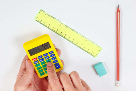 Hands calculate using a calculator over a workplace of the engineerの写真素材