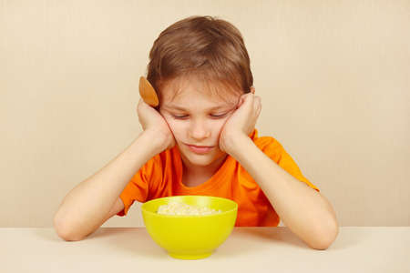 Little boy does not want to eat a cerealの写真素材