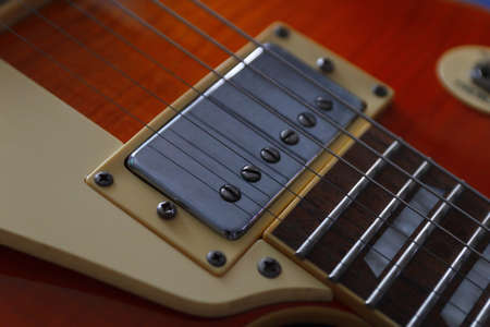 Closeup of the vintage electric guitar. Detail, selective focus. Low key.の写真素材