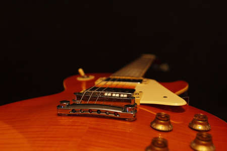 Electric guitar closeup on the black background. Selective focus.の写真素材